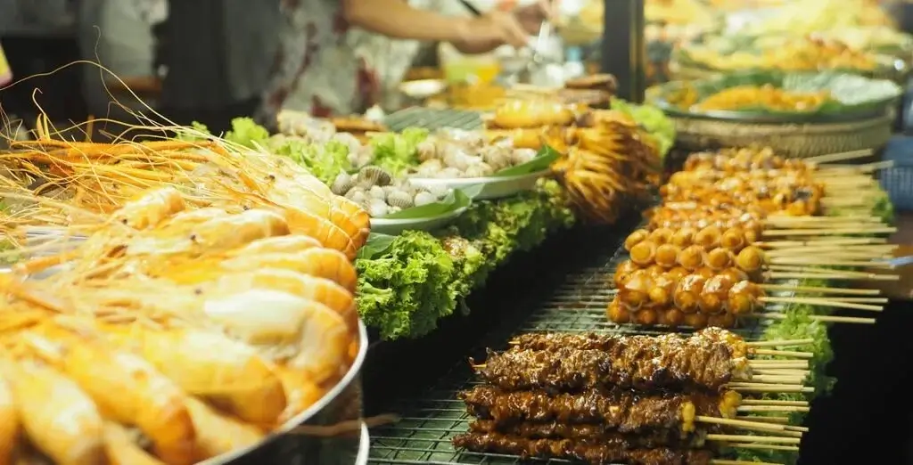 Delicious street food being prepared at a night market in Thailand