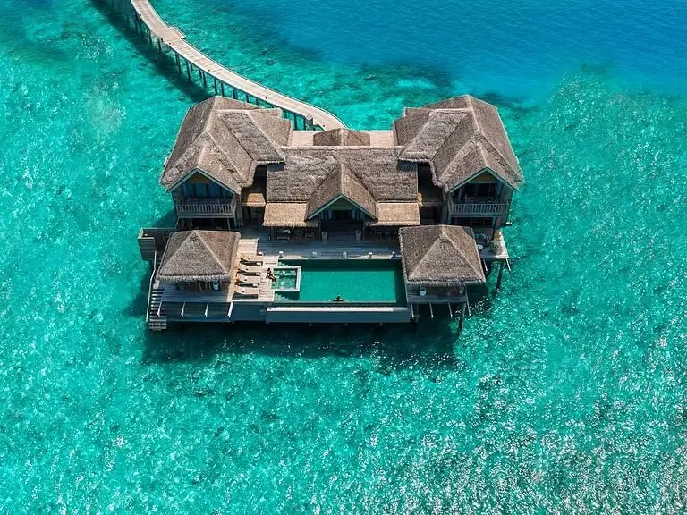 Aerial view of a luxurious overwater bungalow in the Maldives