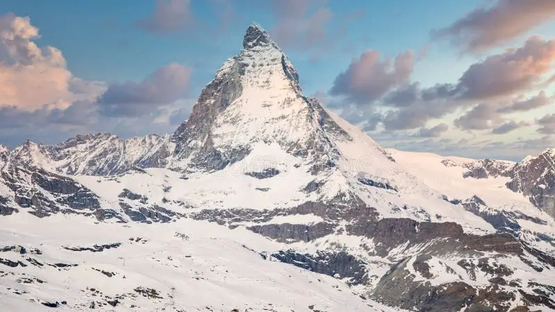 The iconic Matterhorn peak in the Swiss Alps against a blue sky