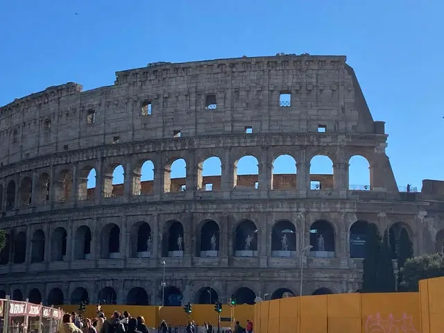 The ancient Colosseum in Rome under a dramatic sky