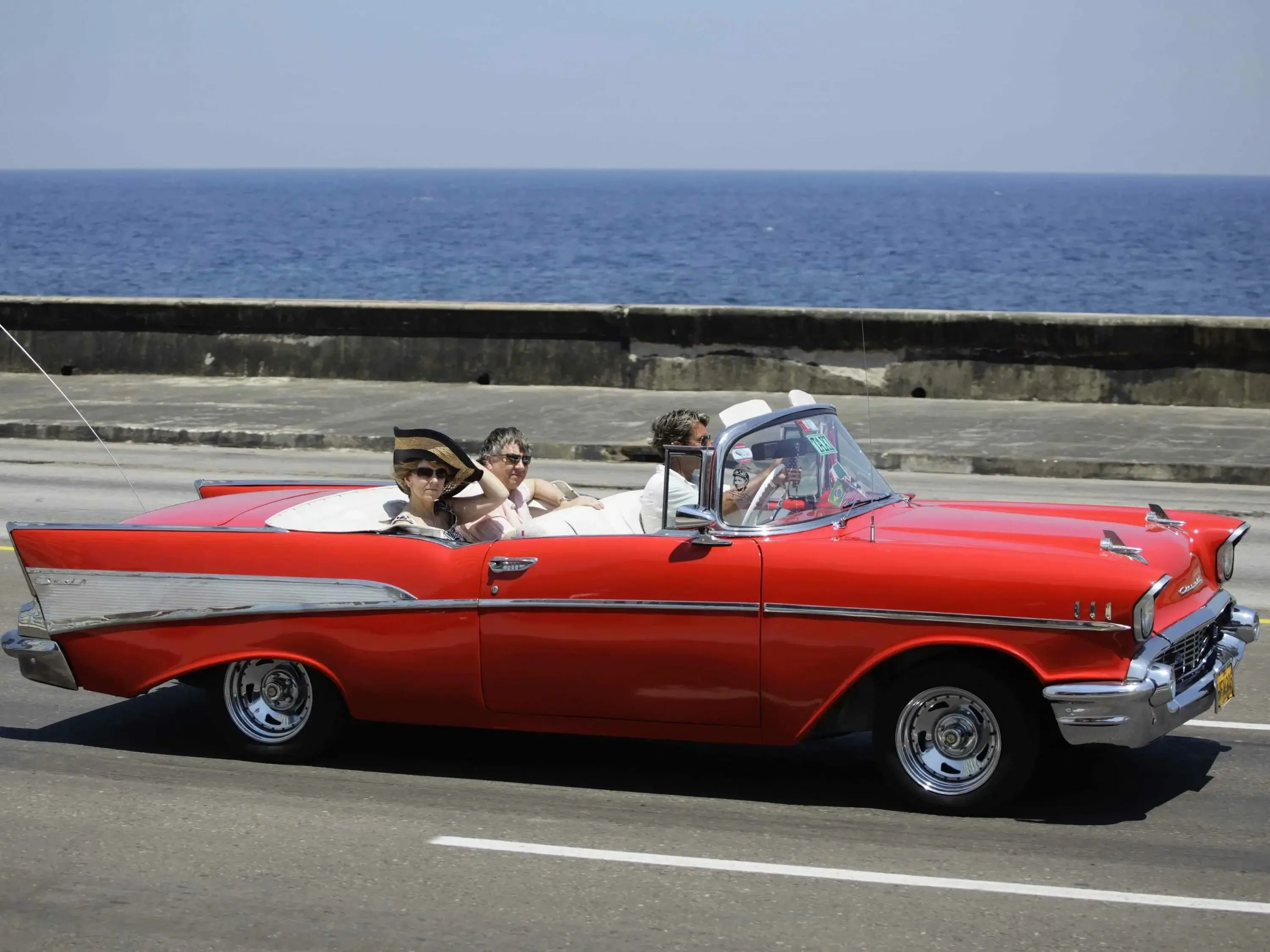 A classic red convertible car on a street in Havana, Cuba